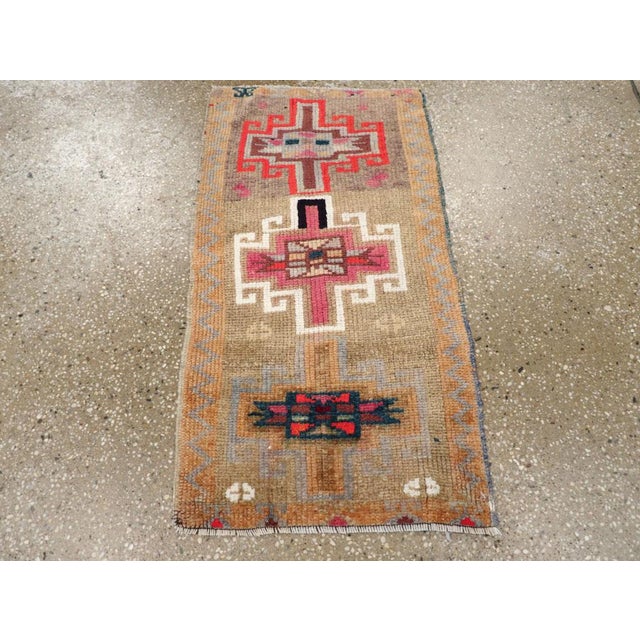 This mid-20th-century Turkish Anatolian throw rug features a vertically arranged composition of three bold geometric...