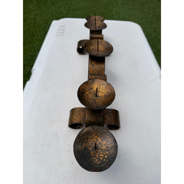 Hand-forged Mexican iron five-light candelabra featuring scrolling wrought iron construction and a richly textured crackle...