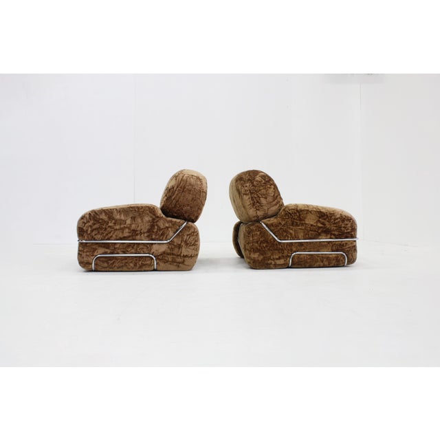 Set of two vintage Italian armchairs from the 1970s. This beautiful set of chairs features a brown, fluffy velvet fabric...