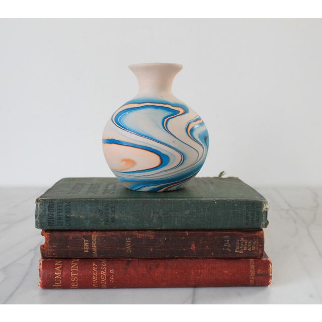 Vintage unglazed Nemadji blue and orange swirl pottery bud vase. Makers mark on bottom. No chips or cracks. Small marks....