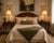 Elegant pair of vintage mahogany Pembroke-style tables featuring classic drop-leaf tops with graceful shaped edges and...
