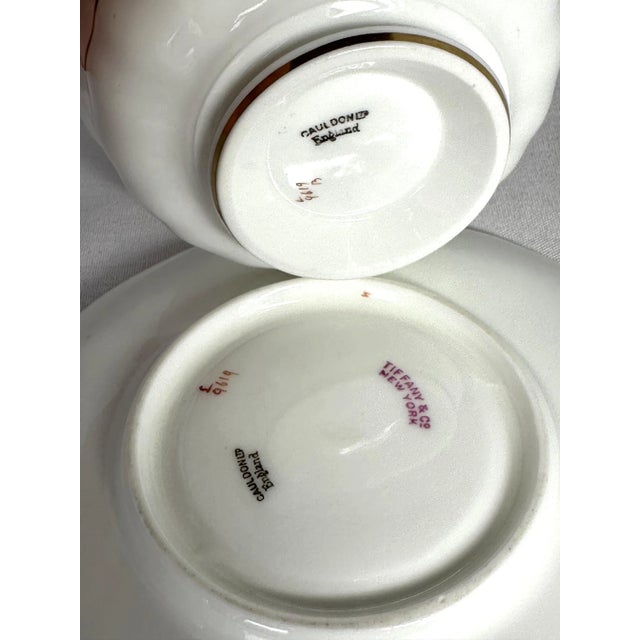 This fine bone china tea cup and saucer was made in the early 1900s For Tiffany & Co. by Cauldon. It has a heavy gilt band...