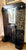Striking Italian coat rack designed by Vittorio Zecchin, featuring a dramatic black lacquered finish with elaborate gilt-...