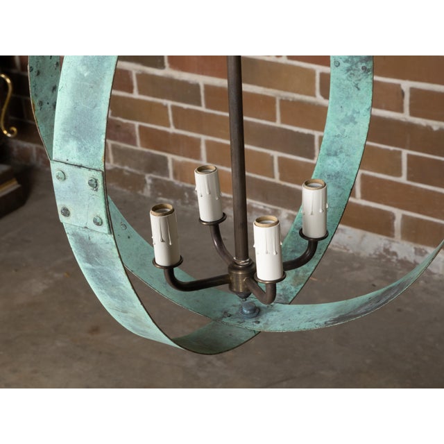 A Midcentury English copper double ring light fixture with four lights and verdigris patina, professionally rewired for...