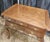 A lowboy chest by Baker Furniture. Brass hardware with a sculpted bevel edge to the top, cabriole legs, and pad feet....