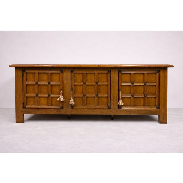 A substantial oak sideboard in a distinctive Alpine / Brutalist style, likely dating from the mid to late 20th century....
