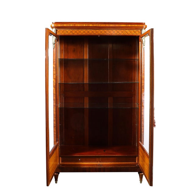 This Louis XVI viewing cabinet, crafted in France circa 1880, is an exquisite example of late 19th-century craftsmanship,...