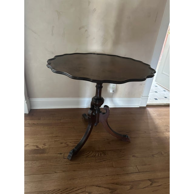 antique mahogany tripod tilt-top occasional table, frequently referred to as a "pie crust" table due to the carved edge...
