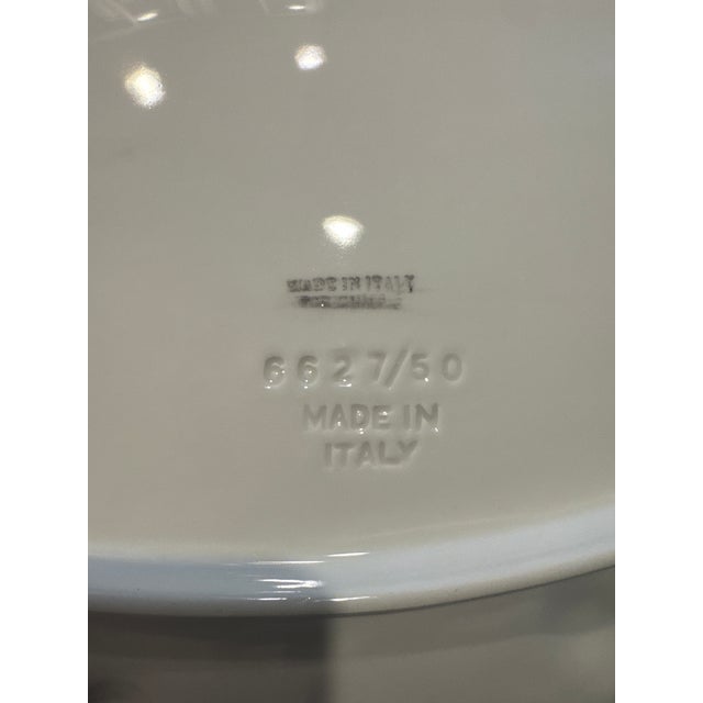 This item is a vintage Italian ceramic oval platter, prominently featuring a high-relief embossed border decorated with...