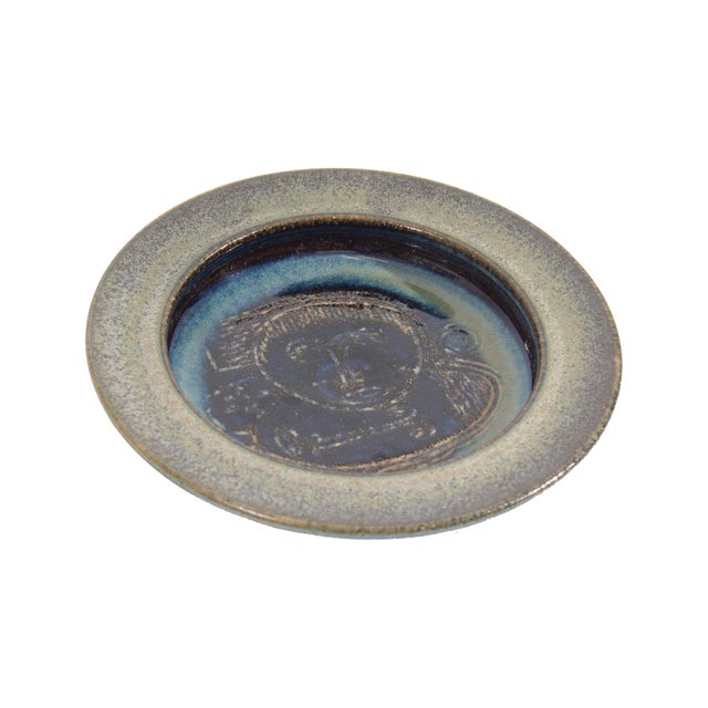 A studio pottery dish or shallow bowl by the American husband and wife art duo Edwin Scheier (1910-2008) and Mary Scheier...