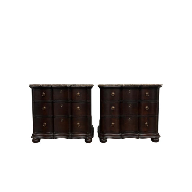 Elegant matching pair of Hickory Chair Furniture Company three-drawer commodes featuring dramatic serpentine fronts, rich...