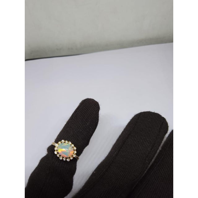 Gemstone details Gold Purity: 18K Solid Gold Opal: 1.05 cts Diamond: 0.15 cts 18K gold Net weight: 1.90 grams code: k
