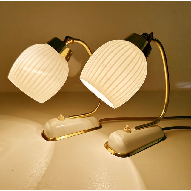 Pair of extremely rare vintage italian bedside table lamps, elongated white enameled base with brass trim, brass stem and...