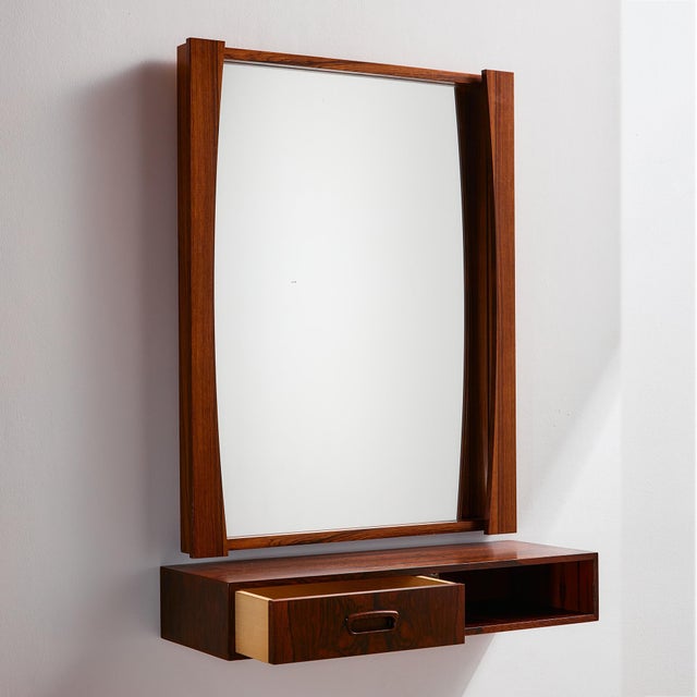A multifunctional piece that can be an exciting addition to the hallway: rosewood framed mirror from the 1960s. The frame...