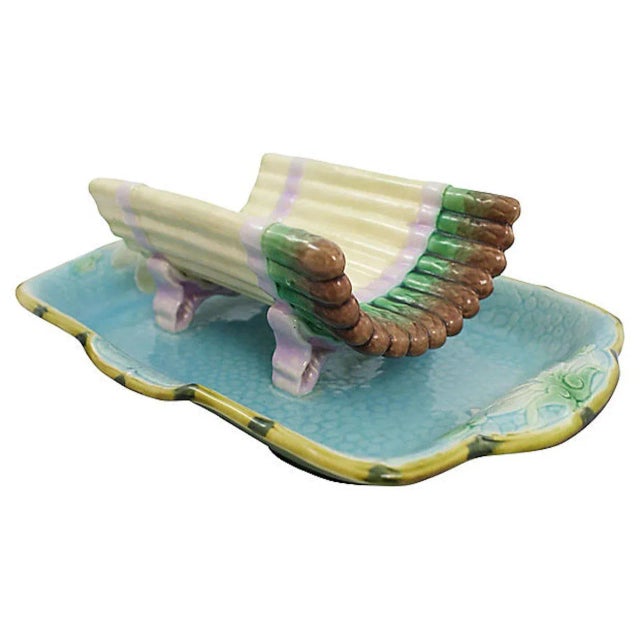 Hand-painted majolica asparagus serving dish featuring lily pad blossom motif. No maker's mark.