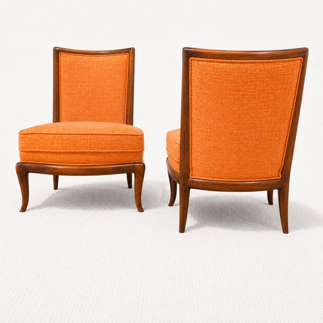Modern slipper lounge chairs. The set is new, and in the manner of Robsjohn Gibbings. Feature walnut frames and gray...