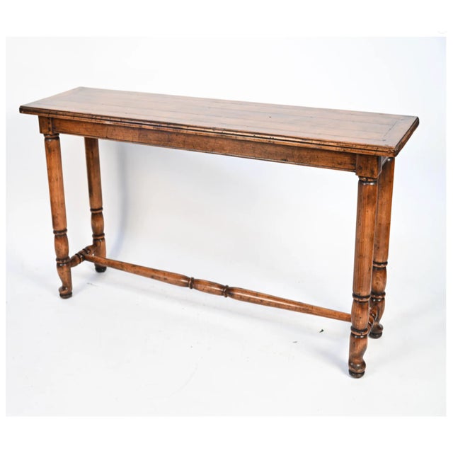 A custom made rectangular console table with an inlaid plank top turned legs and H-stretcher support. Finished in a...