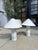 Pair of handmade ceramic table lamps by Kaimin Meehan featuring faceted white ceramic bases and tall pleated shades. The...