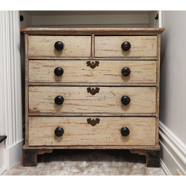 19th century English Victorian era chest of drawers with the original ivory paint. Features the original bronze...