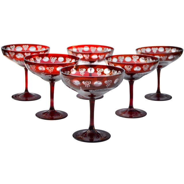 Exquisite set of six midcentury clear and ruby-red stemmed crystal coupes handblown in a meticulously sleek silhouette....