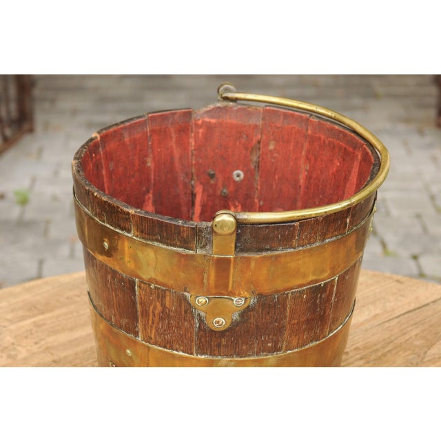 An English oak bucket from the late 19th century, with brass handle and braces. Born in England during the last quarter of...