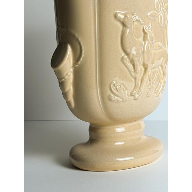 This Art Deco ceramic pedestal vase by Beswick was produced in England during the 1930s and features distinctive relief...