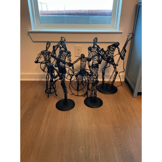 These metal wire sculptures depicts figures playing different instruments There are 5 pieces that are a part of a series...