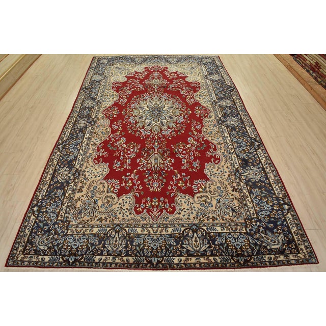 An authentic vintage traditional Kerman rug hand-knotted with fine wool and natural dyes. This oriental rug features a...