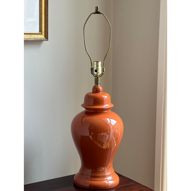 A beautiful circa 1960 ceramic ginger jar table lamp in a vibrant burnt orange glaze. This lamps is absolutely "of the...