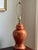A beautiful circa 1960 ceramic ginger jar table lamp in a vibrant burnt orange glaze. This lamps is absolutely "of the...
