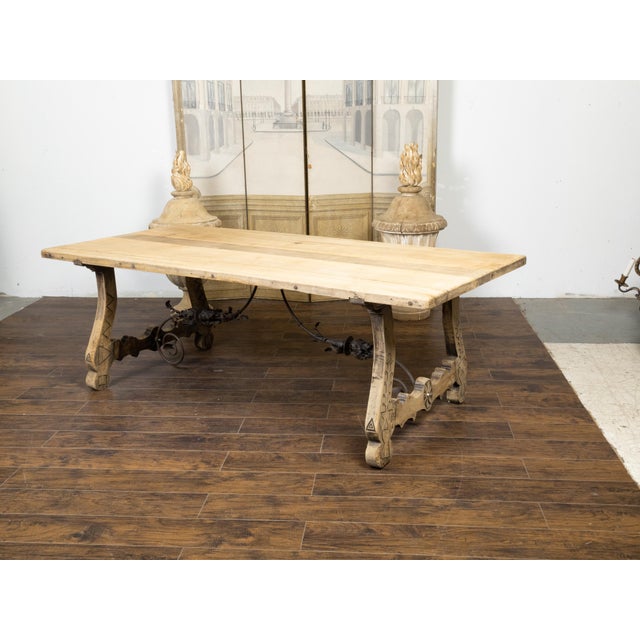 An Italian bleached oak farm table from the 19th century, with Baroque style base, incised carved floral and geometric...