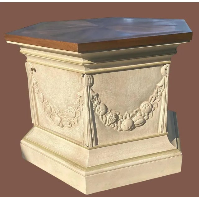 From Drexel a French style storage table in a carved wood swag fruit and flowers motifs with a parchment finish. Solid...