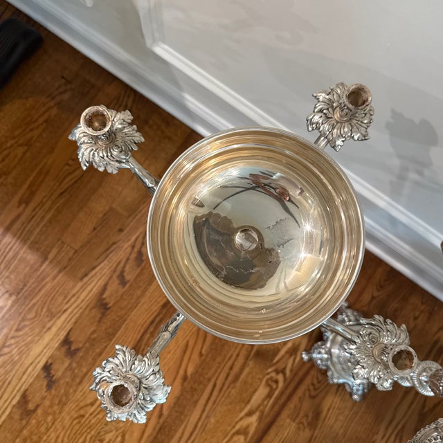A stunning pair of large-scale Rococo-style silver-plated candelabras, each featuring five scrolling candle arms with...