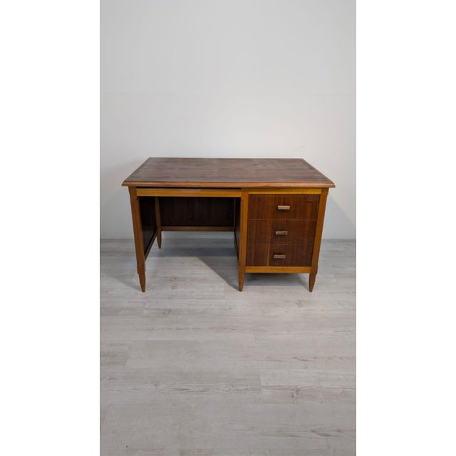 Danish Teak Desk from the 1960s/1970s This solid teak desk from the 1960s/1970s features three drawers and a pull-out...