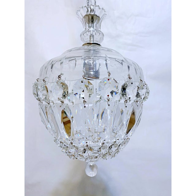 Basket chandelier with hand cut glass dish and A-chain crystals. The chandelier is rewired and restored. It has one Edison...