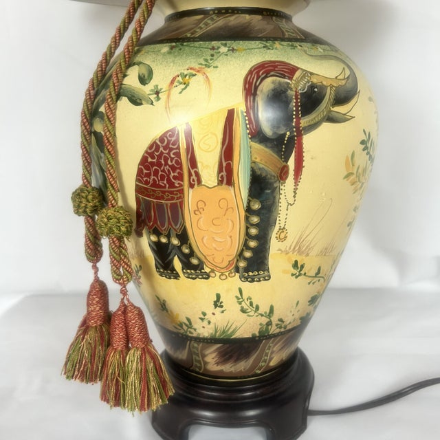 This listing is for a hand-painted ceramic table lamp featuring a decorative tropical elephant motif in a cream, green,...