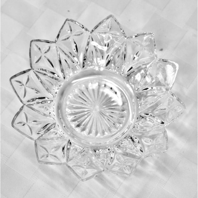 9- Bowls and 5-Saucers. Clear glass, 12-point flower-petal shape with a starburst design in the center, used as bread...
