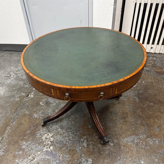 Design Plus Gallery presents a Mid 19th Century Round Leather Top Pedestal Table by Manor House Furniture Works Ltd. The...