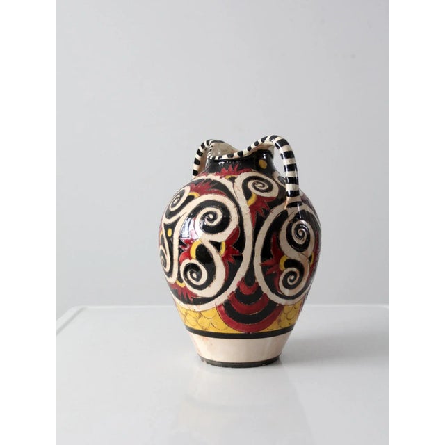Vintage Italian hand-crafted ceramic vase in classic amphora form. Hand-painted design in cream, black, goldenrod, and red...
