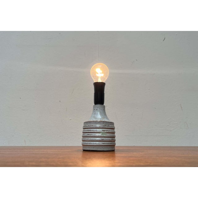 Small ceramic table lamp by the Danish manufacturer Axella from the 1960s. A traditional Danish design. The ceramic base...