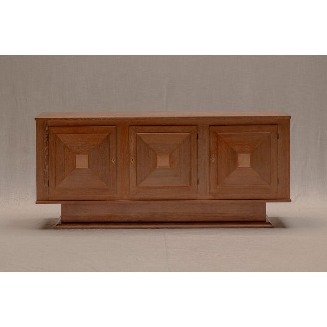 Elegant French mid-century sideboard from the 1950s, crafted in beautifully grained oak and defined by its strong...
