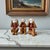 A refined and whimsical set of three vintage Chinese export porcelain monkey figurines, each representing the traditional...