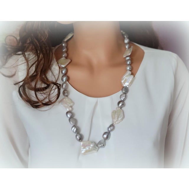 The length of the necklace is 29 inches (74mm). The irregular shape of baroque pearls varies from 14 to 16mm. The size of...