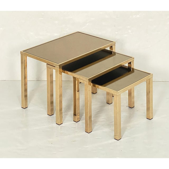 A fine set of three Mid-Century Modern nesting tables from the Hollywood Regency period, by the Belgian design firm, Belgo...