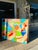 This painting is a vibrant abstract composition characterized by bold geometric shapes and vivid colors. The interplay of...