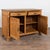 Danish pine sideboard with carved leaf pattern along front door panels. Doors are flanked by elaborate turned columns and...