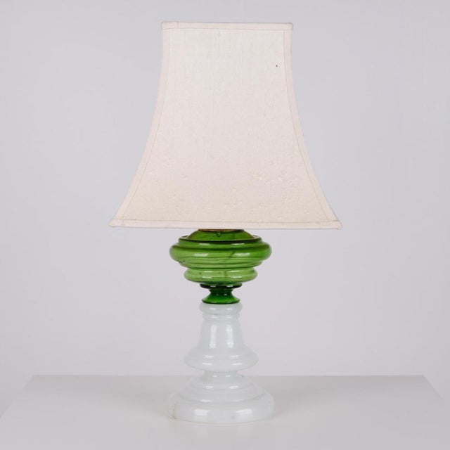 Table lamp made in green and white opaline glass from the 1880s. The lamp features a brass shade support and is fitted...