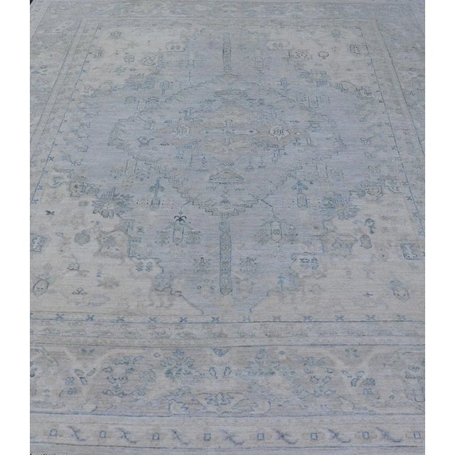 Measures: 8'10 x 11'8 Modern Designed Rug With A Light Blue Background and Tribal Medallion Motifs. Keivan Woven Arts; rug...