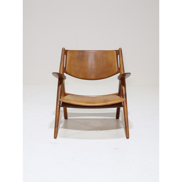Early edition of the ch28 armchair, also known as sawbuck, designed by hans j. Wegner for carl hansen & søn in denmark,...
