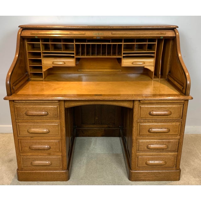 Late 19th Century Exceptional Arts & Crafts or quarter-sawn oak executive roll top desk with raised beveled side panels...